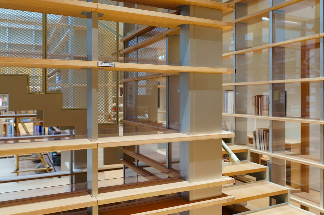 Rows of archived books and research folders on wooden shelves