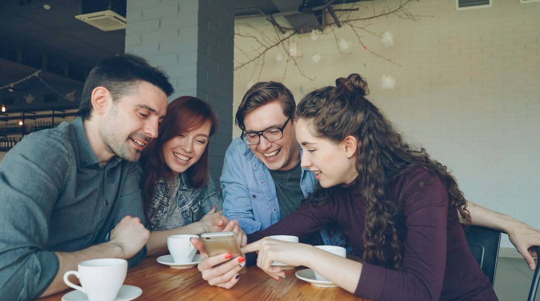 group of friends looking at phones
